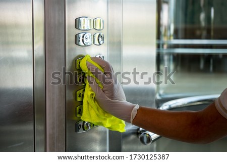 Deep cleaning for Covid-19 (corona  virüs) disease prevention. For safety, spray alcohol, disinfectant on the cleaning cloth wipes in places that are frequently touched at the hotel. Royalty-Free Stock Photo #1730125387