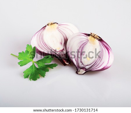 a whole red flat onion and half an onion isolated on a white background