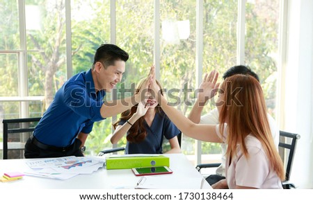 Teamwork with power successful in meeting workplace. Young happy business partner touch hand on desk after discussion and meeting plan of new business online in modern office. team group concept