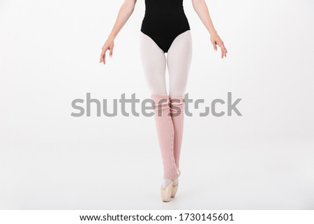 Cropped image of caucasian young woman ballerina practicing and dancing gracefully isolated over white wall background