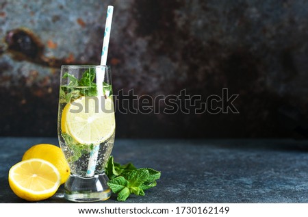 Summer drink with lemon and mint on a dark background. Lemonade.