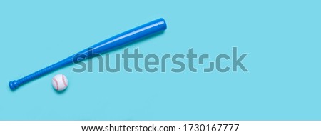 Blue baseball bat and ball isolated on blue background