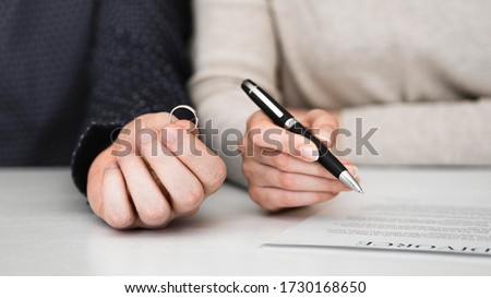 Couple signing divorce divorce settlement agreement. Separation contract document. Royalty-Free Stock Photo #1730168650