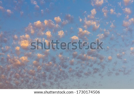 Altocumulus clouds, usually appear between lower stratus clouds and higher cirrus clouds, photographed over the beach, Spain  Royalty-Free Stock Photo #1730174506