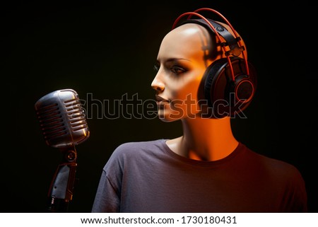 Mannequin with studio retro condenser microphone and professional headphones on it