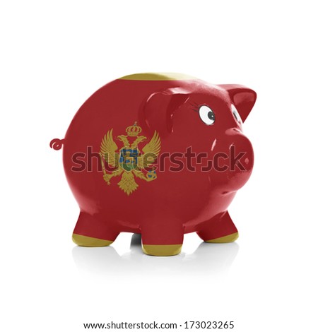 Piggy bank with flag painting over it isolated on white - Montenegro