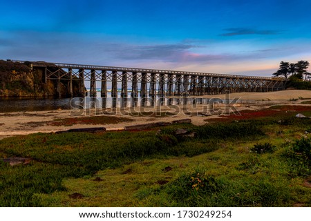 Pudding Creek Trestle, Fort Braggs Historic Bridge, overview on a cloudless morning, low tide Royalty-Free Stock Photo #1730249254