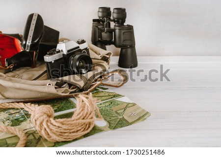 Travel accessories for a mountain trip on white wooden background