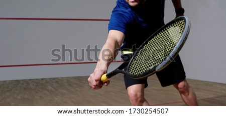 Squash training, young man with a racket on the court.                              Royalty-Free Stock Photo #1730254507