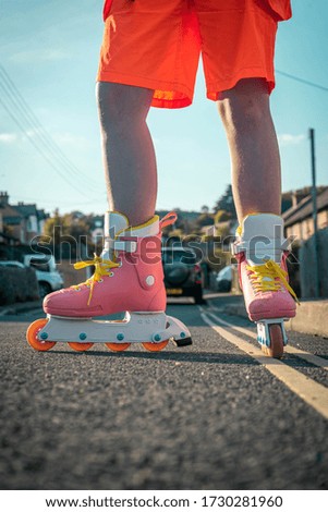 Still shot of a Caucasian girl in a pink set of Roller Skates
