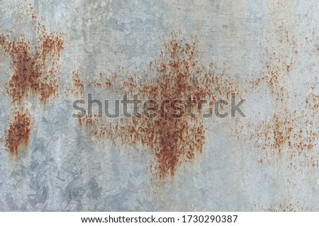 Stains on aluminum surfaces are entirely caused by moisture. Rusty zinc. Zinc plate roof old galvanize fence splash with water. Metal sheet for industrial building and construction.
