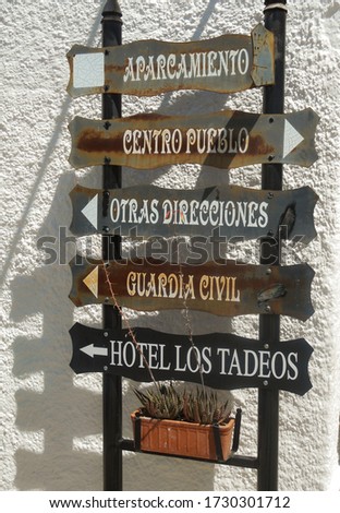Row of old signs giving directions in Spain