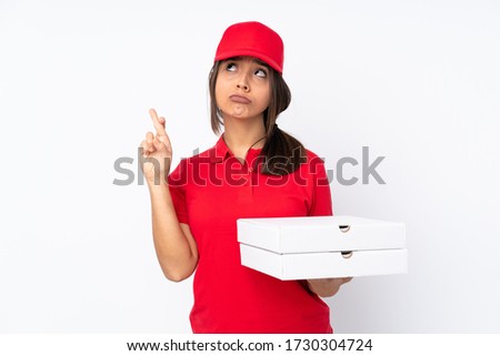 Young Pizza delivery girl over isolated white background with fingers crossing and wishing the best