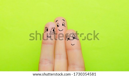 the concept of three fingers as a man a woman and a child hug together and love each other