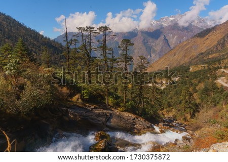 a landscape taken in front of mount katao.situated at lachung, north sikkim.mountain covered with clods and fountain goes downwards between forests.