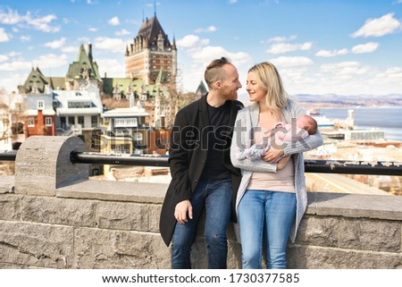 A nice Couple with baby in front of Chateau Frontenac at Quebec city Canada
