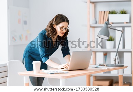 Happy casual beautiful woman working on a laptop at home.