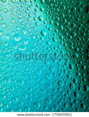 green background with water drops. Drops macro close-up. Texture, background