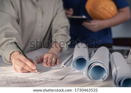 Construction and structure concept of Engineer or architect meeting for project working with partner and engineering tools on fake blueprint for stock photo, contract for both companies. 