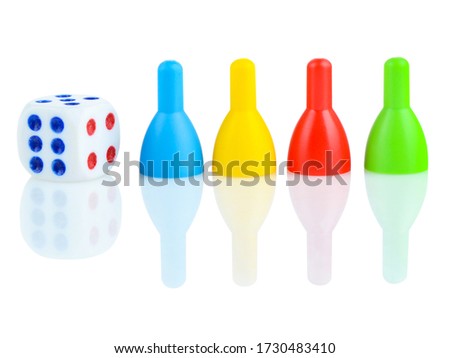 Children's dice and bowling pins in different colors on a white background. The concept of gambling. Developing thinking children's games.