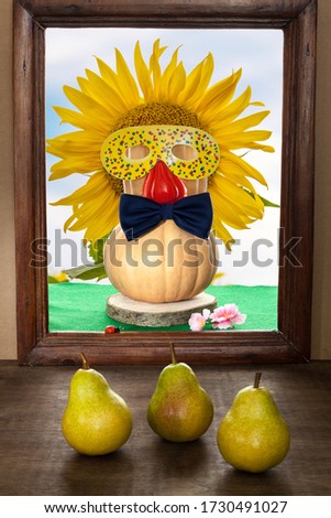 A pumpkin with a bow tie and a masquerade mask against a sunflower and blue sky in an old frame and three ripe pears in the foreground