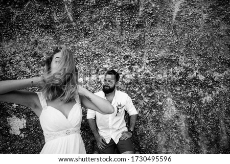 couple in love posing at the cliffs on their wedding day on the island of Bali in Indonesia
