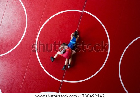 View from above of wrestlers in a leg lace position