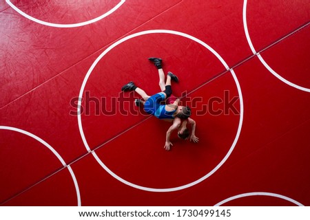 Overhead view of wrestlers in a gut wrench position