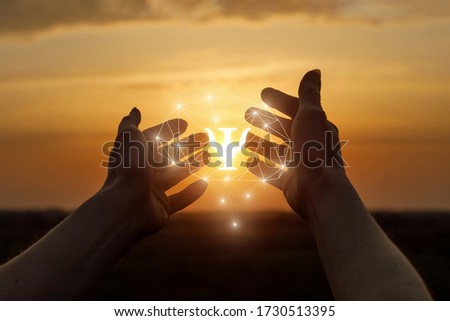 Hands shows the brain and psychology icon on a background of sunny sunset.