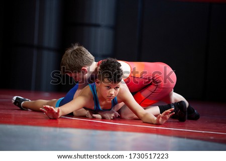 Youth wrestlers in the top and bottom position for freestyle and greco roman wrestling