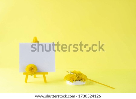 A blank canvas on an easel. Bright solar composition. Empty space can be used for invitations, greetings, notes, and messages.