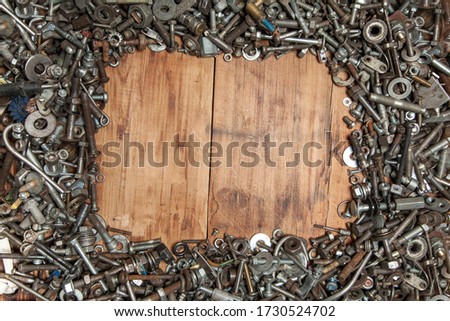metal bolts and nuts on a wooden coating.