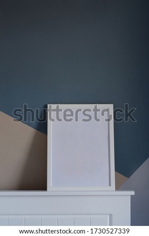 Empty blank white picture or photo frame with copy space on mantel leaning against wall