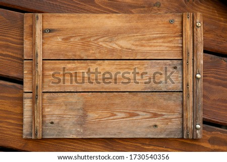Texture and background. Old wooden decorative sign or plate made of wood. Empty space for text message in the middle