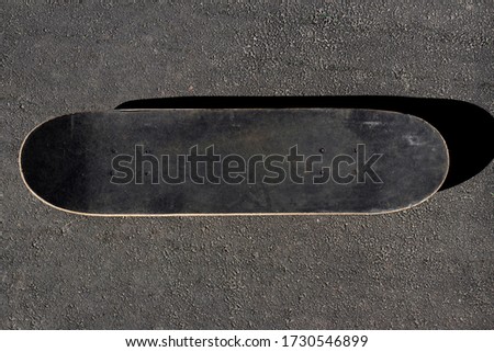 Old skateboard on the asphalt background, extreme sport, skateboarding