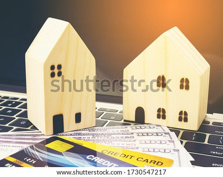 Small wooden houses with modern design and Credit card for home loans concept.