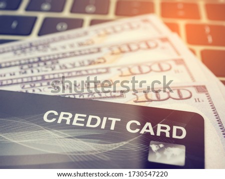 Credit card close up and dollar banknote with keyboard, Shopping online concept.