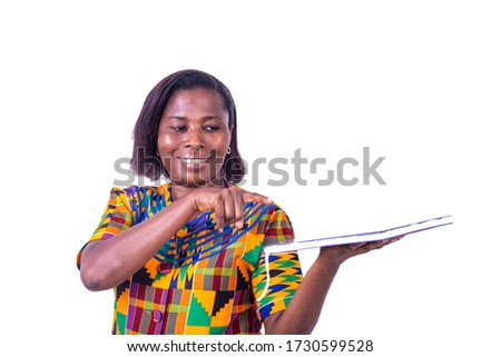 beautiful happy adult woman pointing with hand and finger on book while smiling.