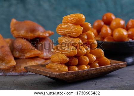 Arabic Cuisine: Middle Eastern traditonal dessert/Ramadan dessert "Balah Al-Sham" or "Balah El Shaam" served with honey syrup and pistachio. Close up with copy space. Royalty-Free Stock Photo #1730605462