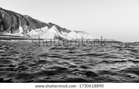 Travel black and white photography.Scenic view of unique spectacular mountains on Iranian Mofanneq Beach on Hormuz Island,Hormozgan Province,Persian Gulf, Iran.Dramatic rocky salty volcanic background