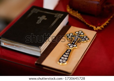 religious items, bible and gold cross prepared for a ceremony, inside a Christian Orthodox Church. selective focus
