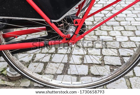 Close up view at a bicycle wheel with metal spokes