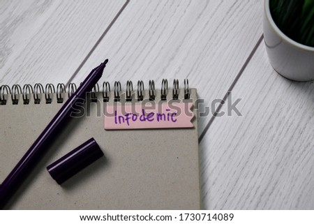 Infodemic write on sticky notes isolated on office desk