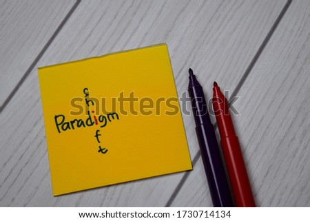 Paradigm and Shift write on sticky notes isolated on office desk