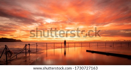 Beautiful moody red sunrise over Bronte Beach in Sydney Australia
