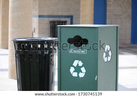 Trash and recycle bins in a city park