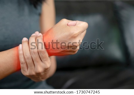 Woman with pain in his hand because of hard work, Ache in human body , office syndrome,Bone and joint disease, Concept healthcare and medical.