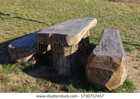 benches and table made from a single wooden trunk in a cottage