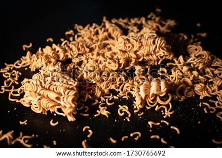 close-up image of dry instant noodle, black background