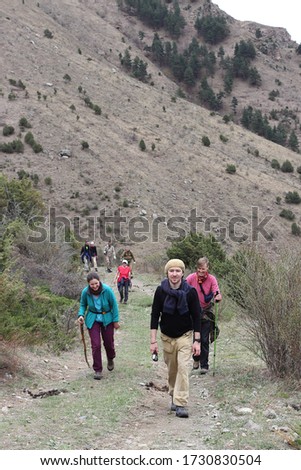 Good guys, tourists on the route of conquering the Caucasus Mountains. Sporty girls and guys in search of adventure in an unusually beautiful, atmospheric place, Karachay-Cherkessia, Russia.